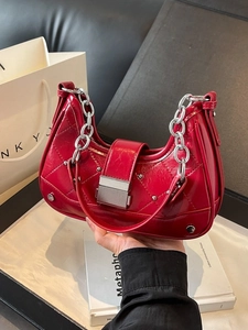 Red quilted leather baguette bag with silver studs and chain strap in a premium setup