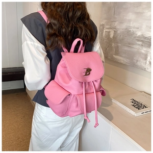 Pink lychee grain leather backpack with drawstring closure and metal B-logo detail