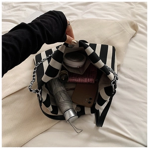 Interior detail of striped canvas tote showing capacity for umbrella and wallet