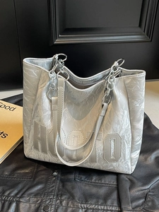 Metallic silver tote bag with crinkled leather texture and chain straps for casual wear