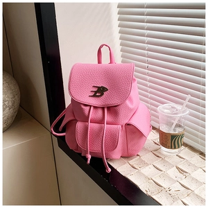 Detailed macro of pink lychee leather backpack with B-logo metal buckle and drawstring closure