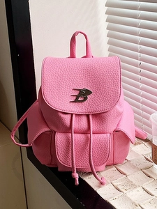 Pink PU leather backpack with lychee texture and silver B-logo on natural window background