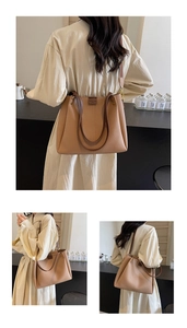 Detail of large beige tote bag showing lychee leather texture and adjustable strap