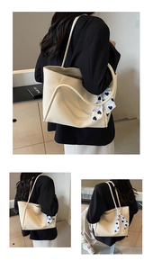 Detailed view of beige faux leather tote bag with heart print scarf and shoulder straps