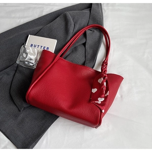 Chic red lychee pattern PU tote bag with heart print silk scarf on white fabric