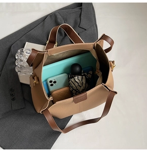 Spacious interior of a brown tote bag showing ample storage for tablets and daily items