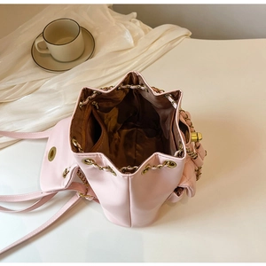 Dettaglio dell'interno dello zaino rosa con fodera marrone e tasca con cerniera interna