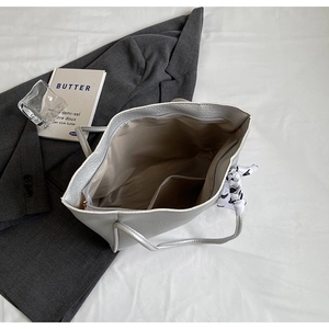 Top view of silver tote bag interior with zipper pocket and decorative silk scarf