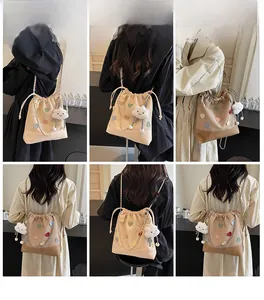 Collage of model wearing a large beige bucket bag with colorful heart patches and cloud charm