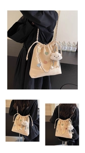 Detail of beige bucket bag featuring colorful heart patches and cloud plush charm decoration