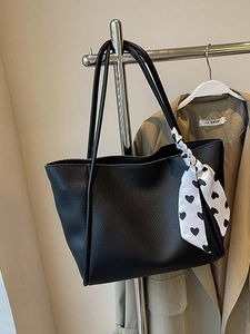 Chic black lychee texture tote bag with heart scarf detail for commuting women