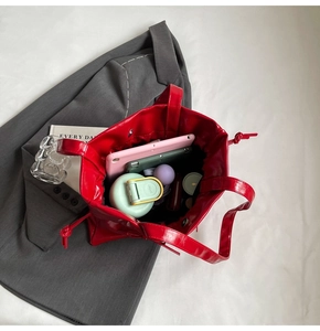 Top view of large red patent leather tote showing spacious interior for daily essentials