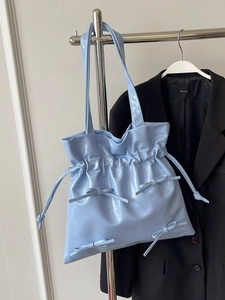 Light blue ballet style tote bag with drawstring pleats and small bow details