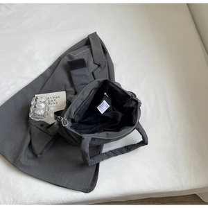 Vue interne d'un sac messager en nylon gris foncé avec grand espace et sangle large