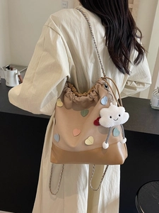 Women's large capacity bucket backpack with colorful hearts and chain strap on model