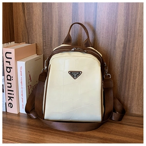 Detailed view of beige backpack with geometric stitching and metal JIPIN logo
