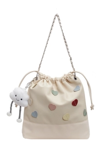 Off-white drawstring bucket backpack with colorful heart patches and cloud charm