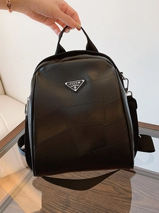 Women black leather backpack with minimalist triangle logo and patchwork texture