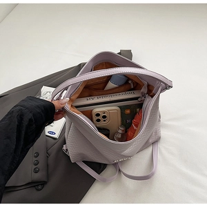 Detail of lavender quilted backpack showing spacious interior compartments and storage