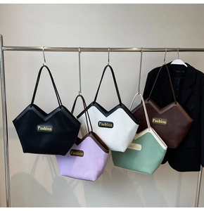Detail of multi-color tote bags featuring V-shaped cuts and vertical pleat textures