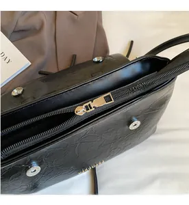 Detailed macro view of black pleated texture PU leather bag with smooth metal zipper