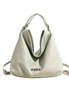 Minimalist mint green quilted tote bag with silver heart studs and top handle