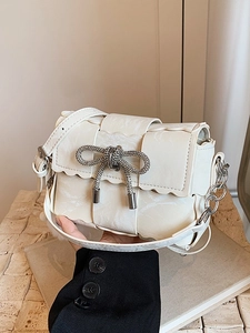 Cream woven mini crossbody bag with rhinestone bow and wavy edge detail for women