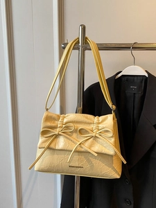 Chic cream yellow ballet-style shoulder bag with pleated texture and bow detail