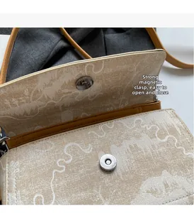 Detail of compact beige canvas bag showing a strong magnetic buckle for easy opening