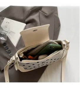 Detailed interior of polka dot baguette bag showing phone and lipstick storage