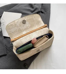 Detail view of the spacious inner compartment of the printed canvas crossbody bag