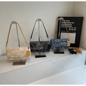 Detailed comparison of three printed shoulder bags in beige, black and blue colors
