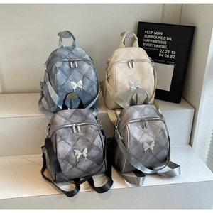 Detailed display of four quilted backpacks with diamond patterns and butterfly buckles