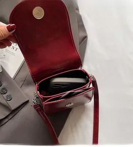 Interior view of burgundy leather crossbody phone bag showing space for phone and lipstick