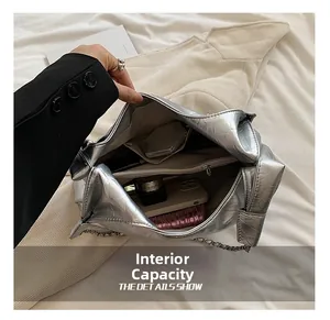 Internal capacity detail of silver metallic tote bag with multiple pockets and storage space