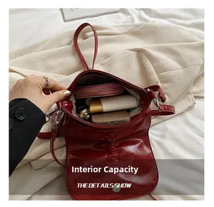 Macro view of the internal storage space of the burgundy PU leather crossbody bag