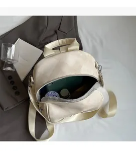 Detail view of large interior showing cream backpack storage for tablet and umbrella