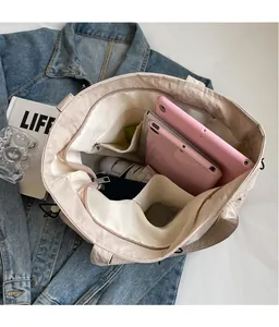 Interior view of beige pleated tote bag showing large capacity and multiple pockets