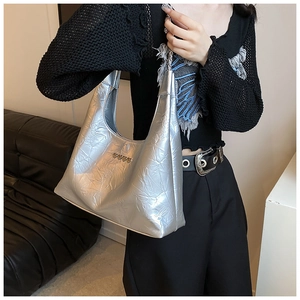 Detail of silver metallic hobo bag with heart rivets and crinkled texture fabric