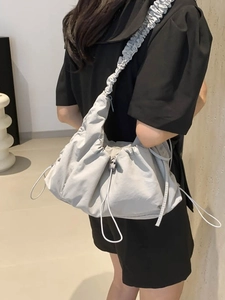 Large pleated canvas tote bag in light grey with ruffled shoulder straps for daily casual use