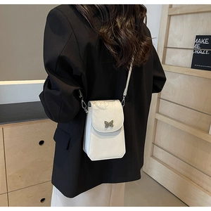 Detail of white leather crossbody phone bag with an elegant metal butterfly clasp buckle