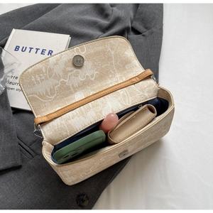 Detail of a beige printed flap bag showing internal capacity for phone and wallet