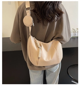 Detailed back view of a beige hobo bag with wide strap and matching round coin purse