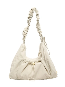 Minimalist beige pleated crescent tote bag with scrunchie shoulder strap on white background