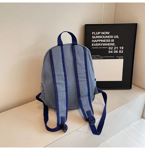 Close-up of durable denim backpack with reinforced blue straps and premium stitching