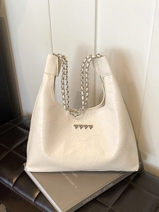Creamy white pleated tote bag with silver chain strap and heart-shaped metal buckles