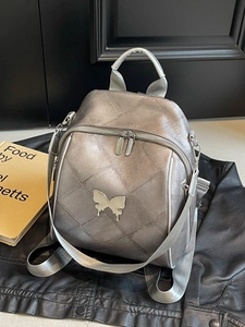 Silver metallic backpack with butterfly buckle and quilted texture for women fashion