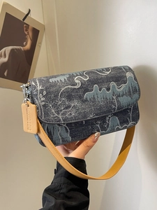Blue jacquard crossbody bag with landscape pattern and yellow leather strap