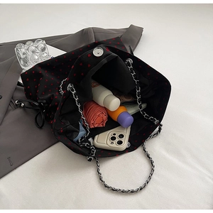 Interior view of large capacity tote bag showing chain strap and daily essentials storage