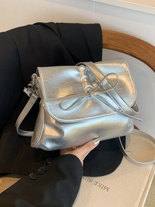 Silver metallic pleated crossbody bucket bag with bow detail and leather shoulder strap